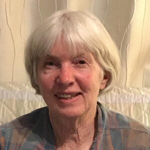 Woman with white bob smiling at camera