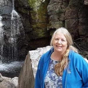 Woman with long blond hair at waterfall