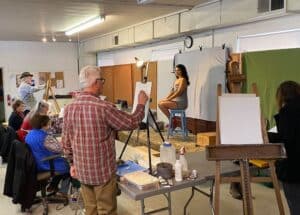 Artists painting a pretty model
