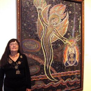 Bonnie Bisbee next to one of her paintings