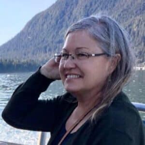 Woman smiling with mountains in background